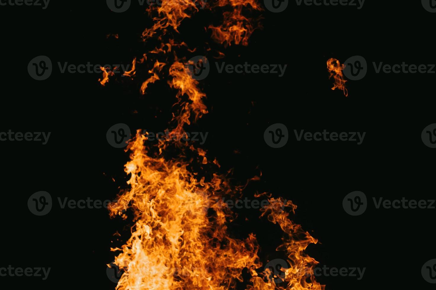 Fire embers particles over black background. Fire sparks background. Abstract dark glitter fire particles lights. bonfire in motion blur. photo