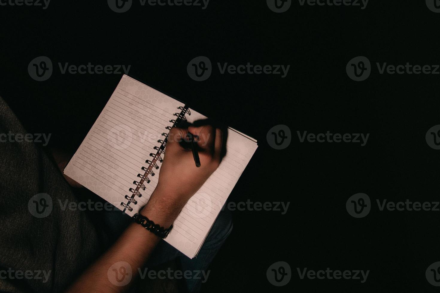 Man writing on notepad with copyspace photo