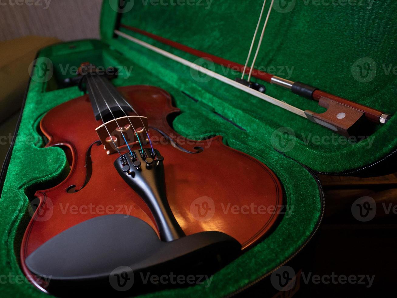 Red wooden violin in box photo