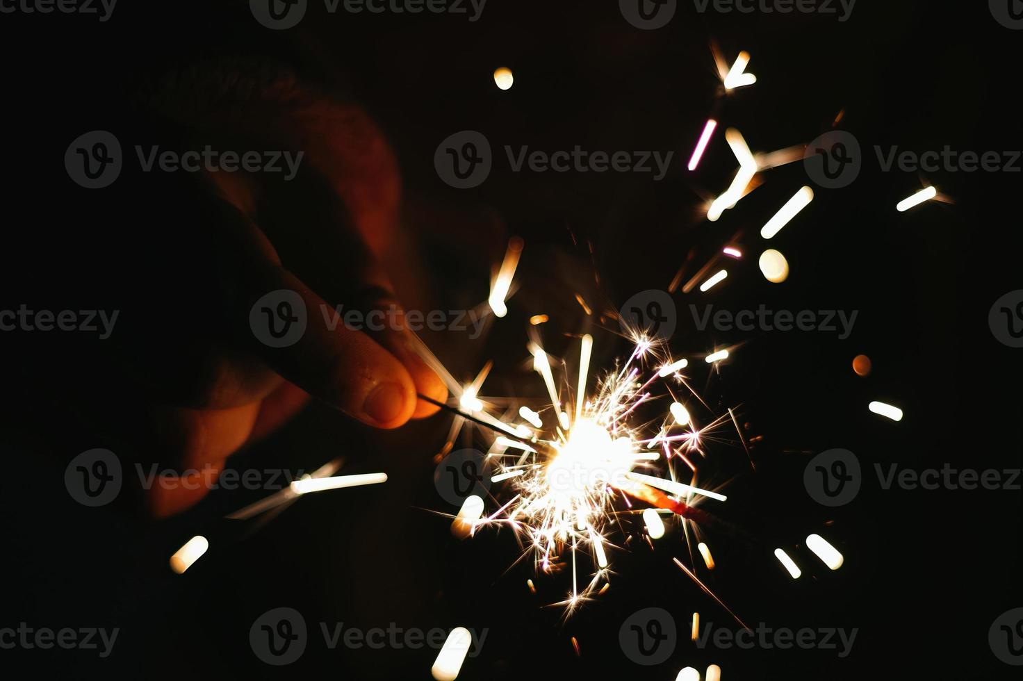 Festive sparkler with sparks in hands Christmas Background photo