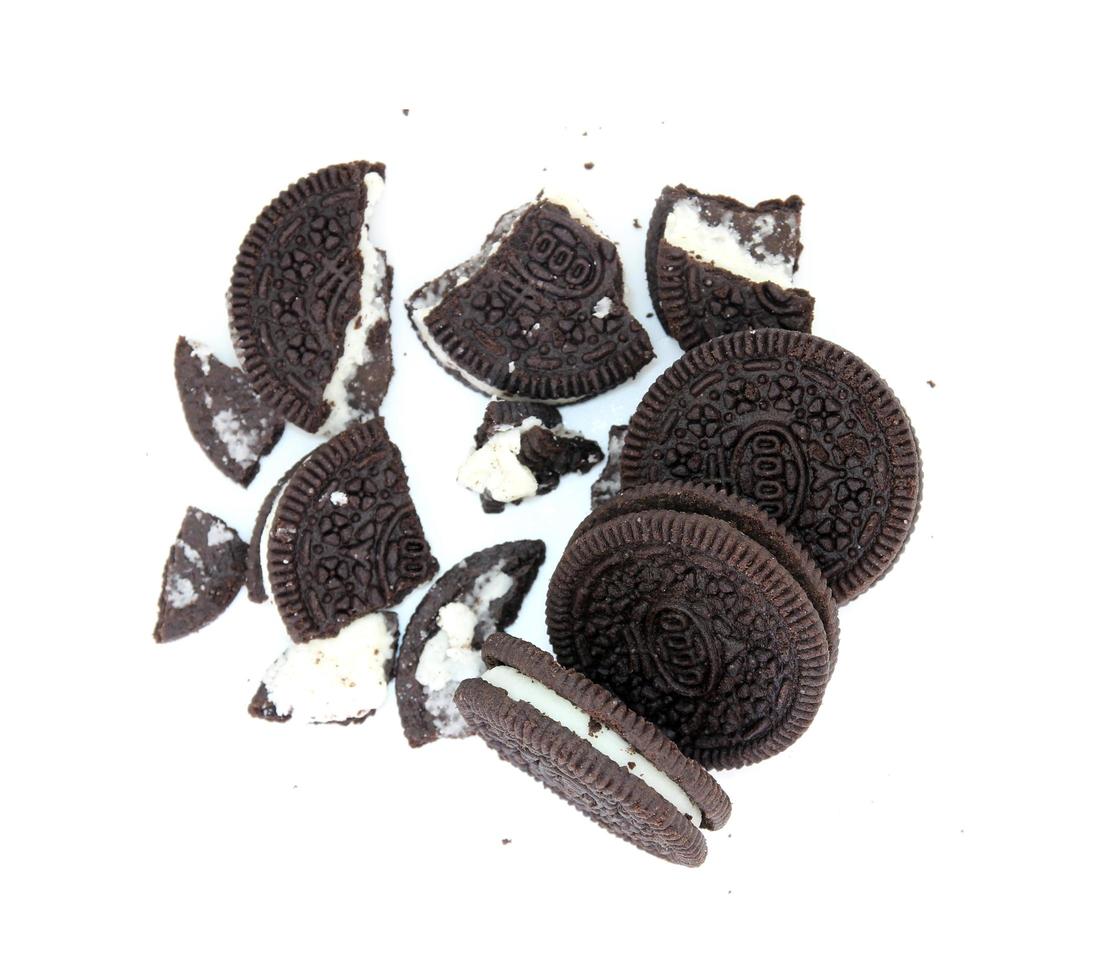 Sandwich chocolate cookies with a sweet cream with crumbs isolated on white background photo