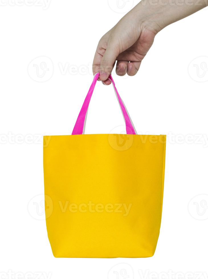 hand holding yellow fabric bag isolated with clipping path for mockup png