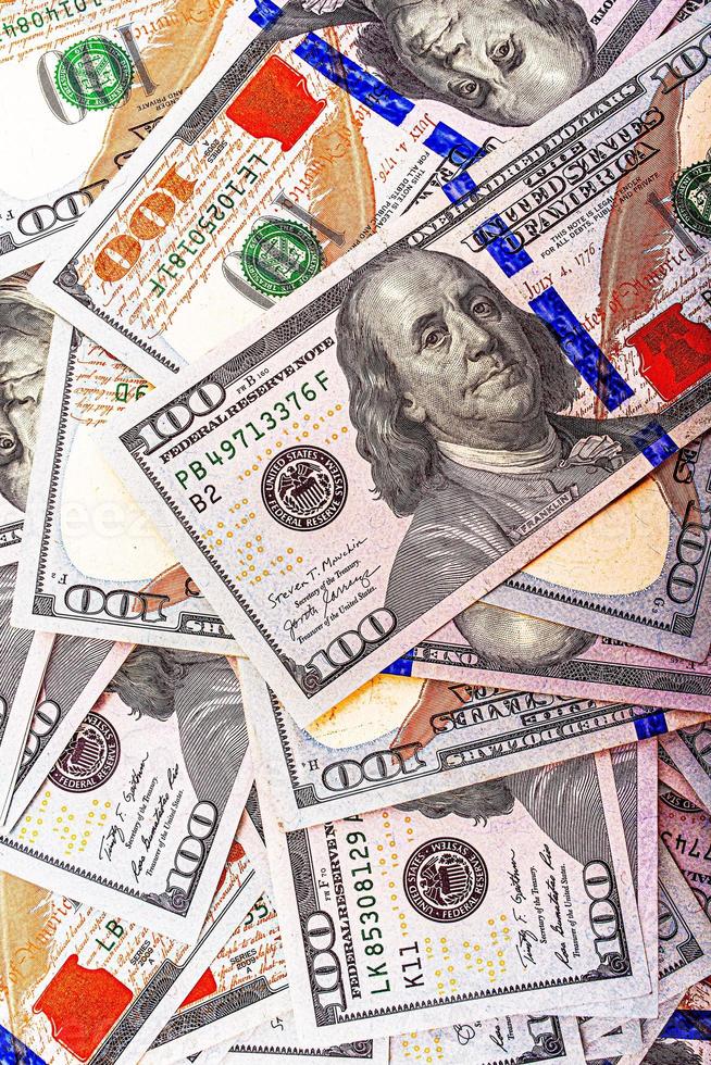 Dollars on a red wooden background. Money on the table. American dollars. photo