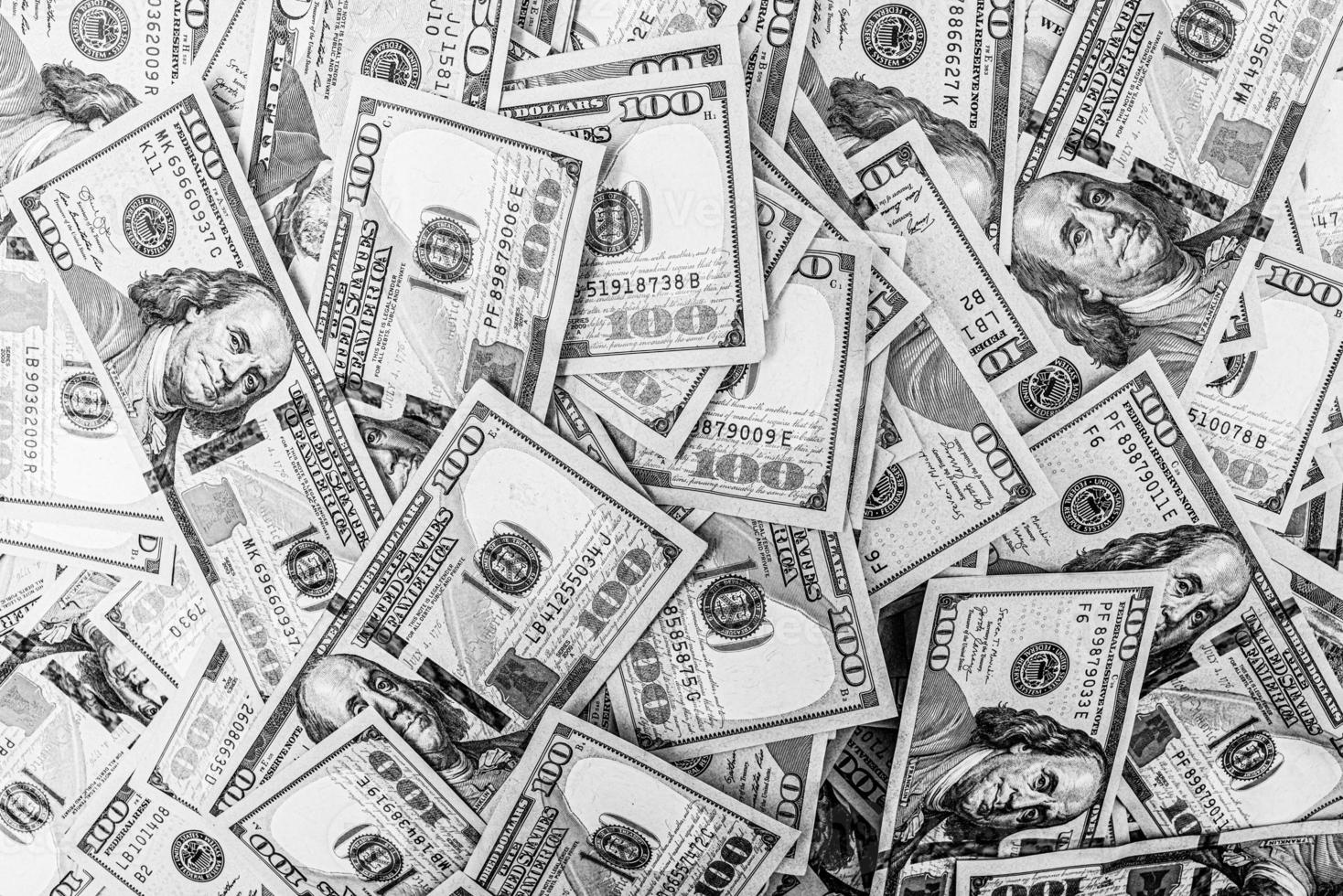 Black and white photo of 100 dollar bills. Money American currency as background.