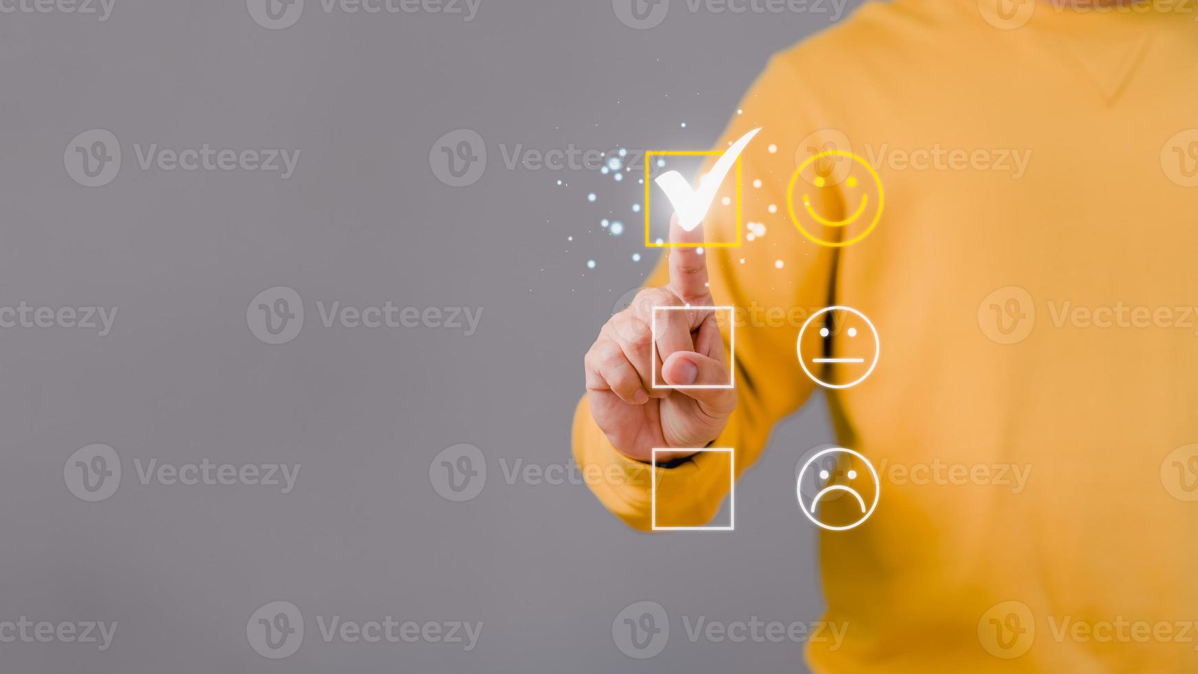 Man touching the virtual screen on the happy smiley face icon to give satisfaction in service. Rating very impressed. Customer service and satisfaction concept. photo