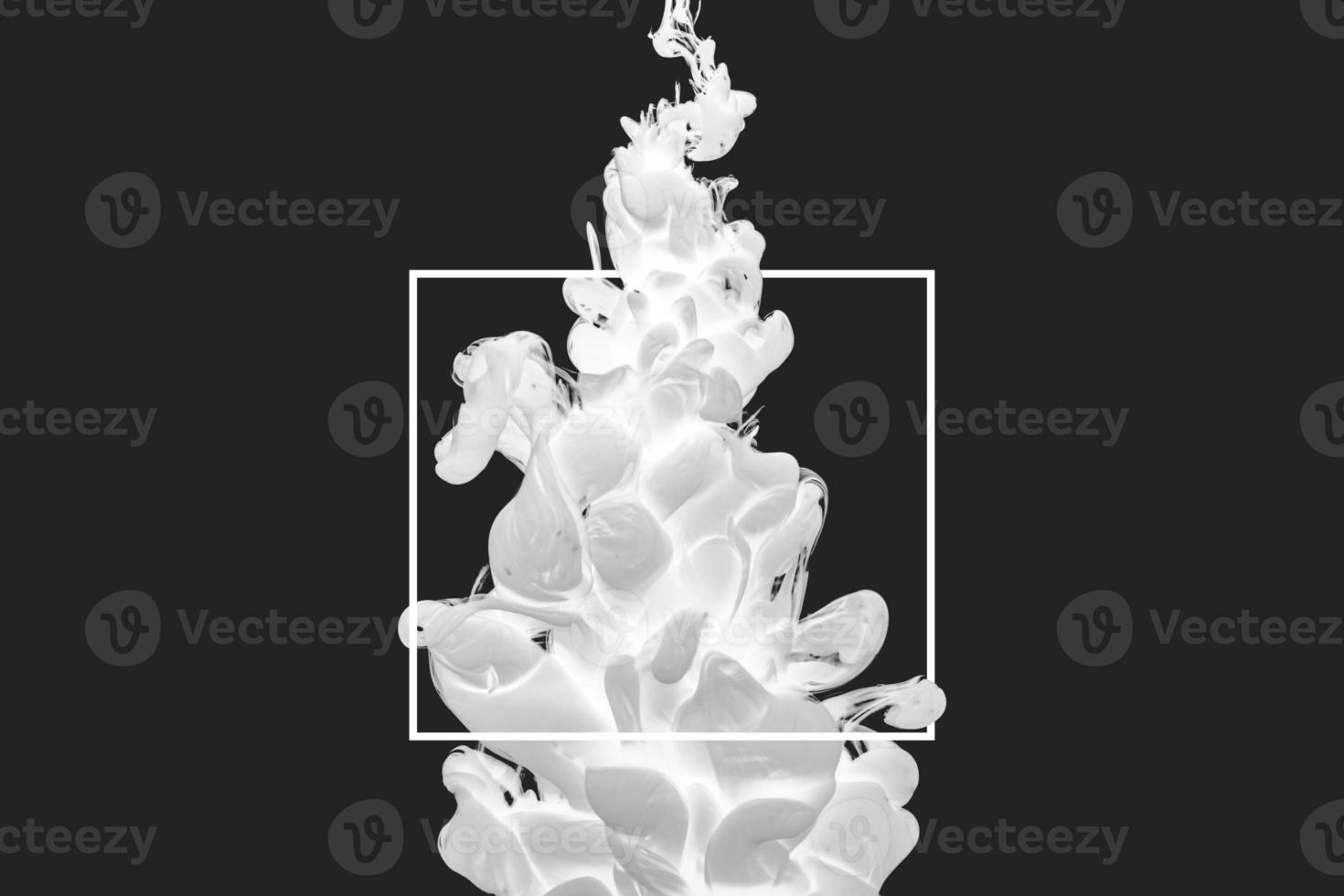 acrylic ink in water form an abstract smoke pattern isolated on black background photo