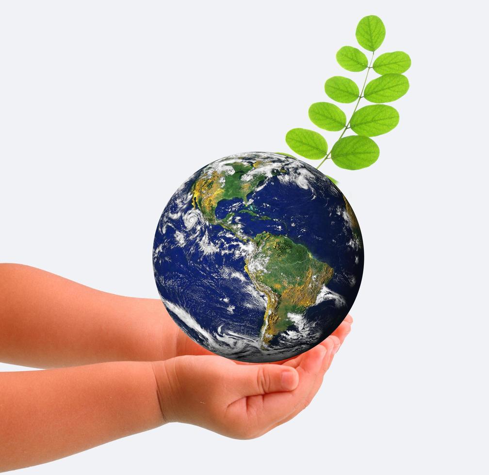 The globe in hands of the child,isolated on a white photo