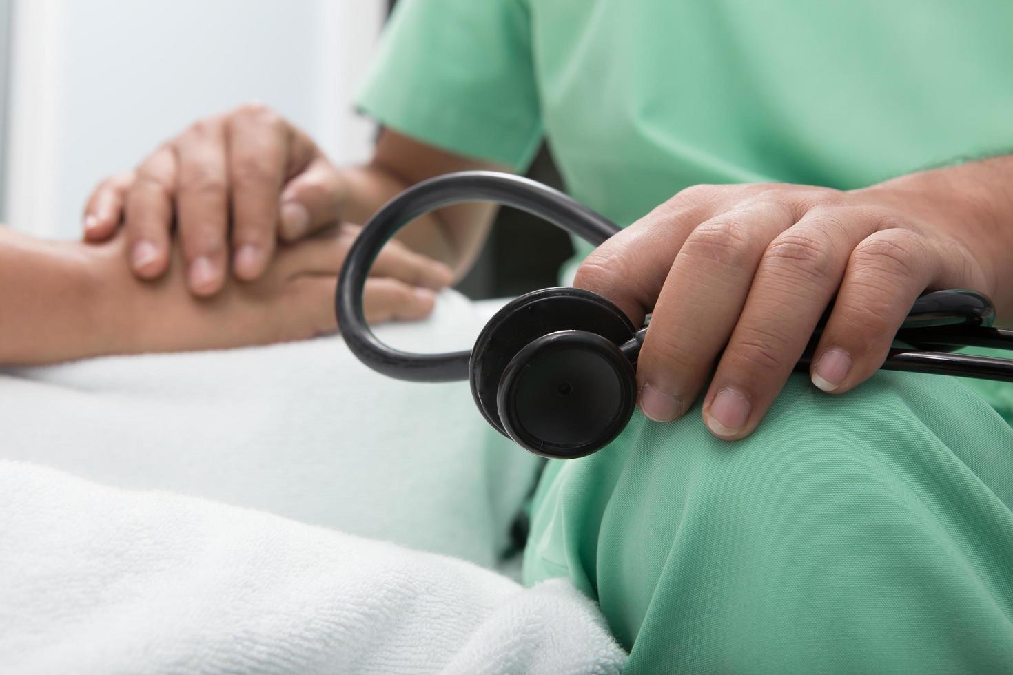 medical doctor holing senior patient's hands photo