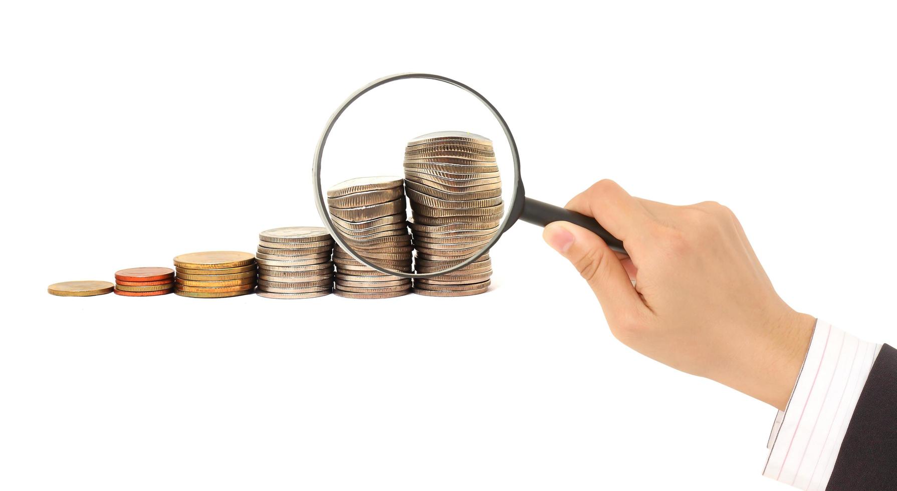 Magnifying glass and lots of gold coins photo