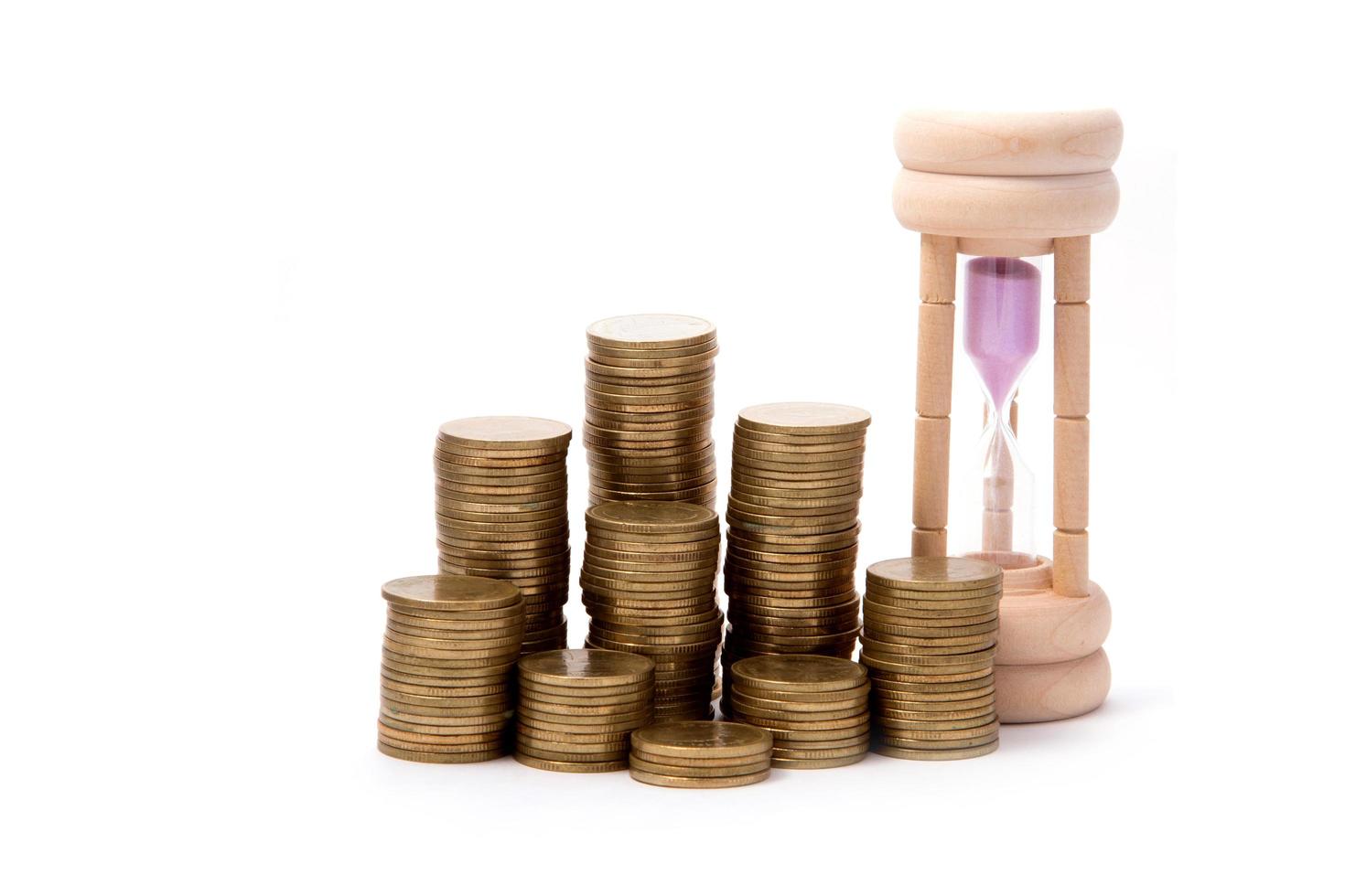 Hourglasses and columns of coins photo