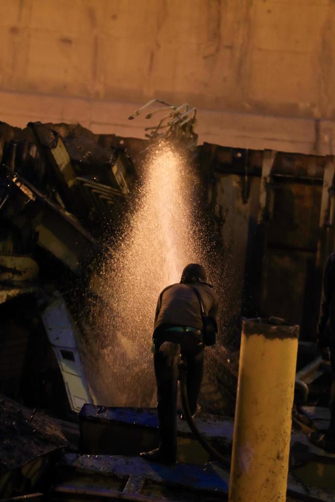 Silhouettes of  firemen before a fire photo