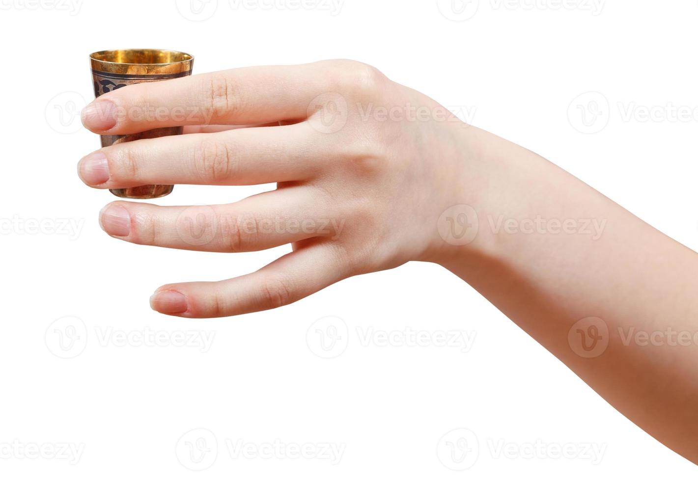 hand holds little metal cup with spirit photo