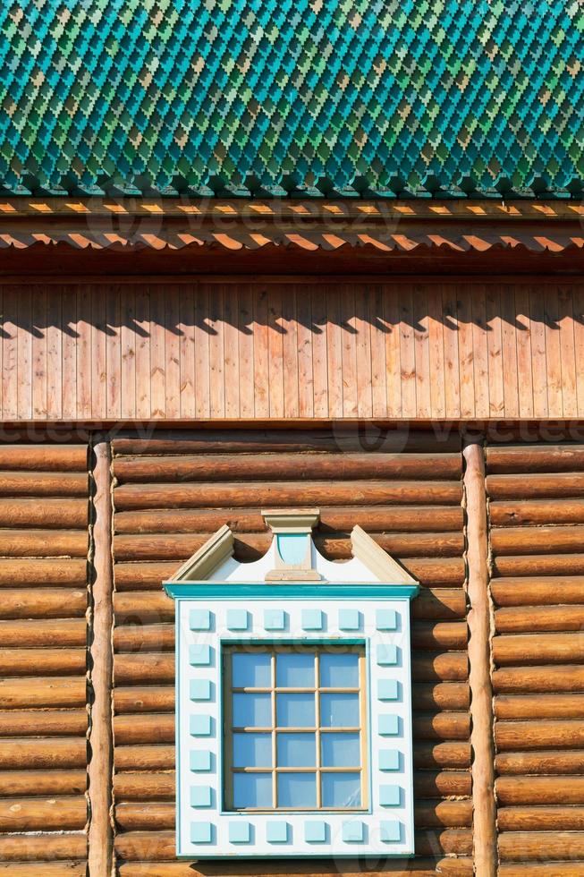 decorated window of old russian log house photo