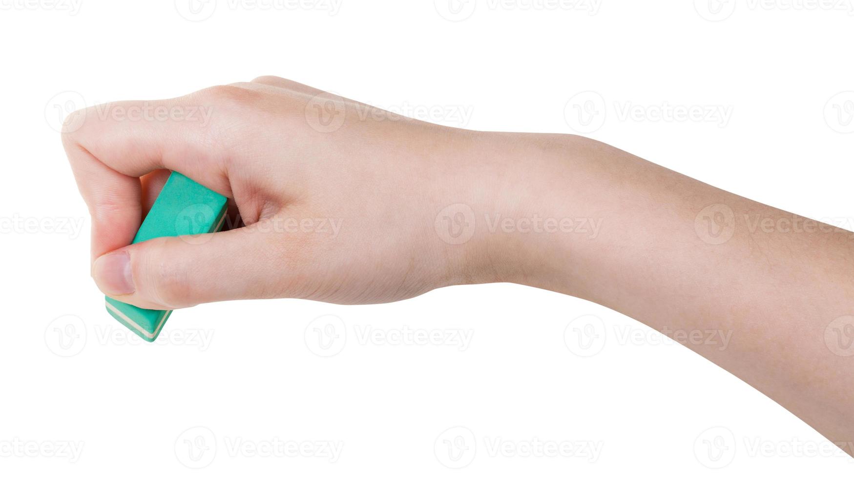 hand with green rubber eraser isolated on white photo
