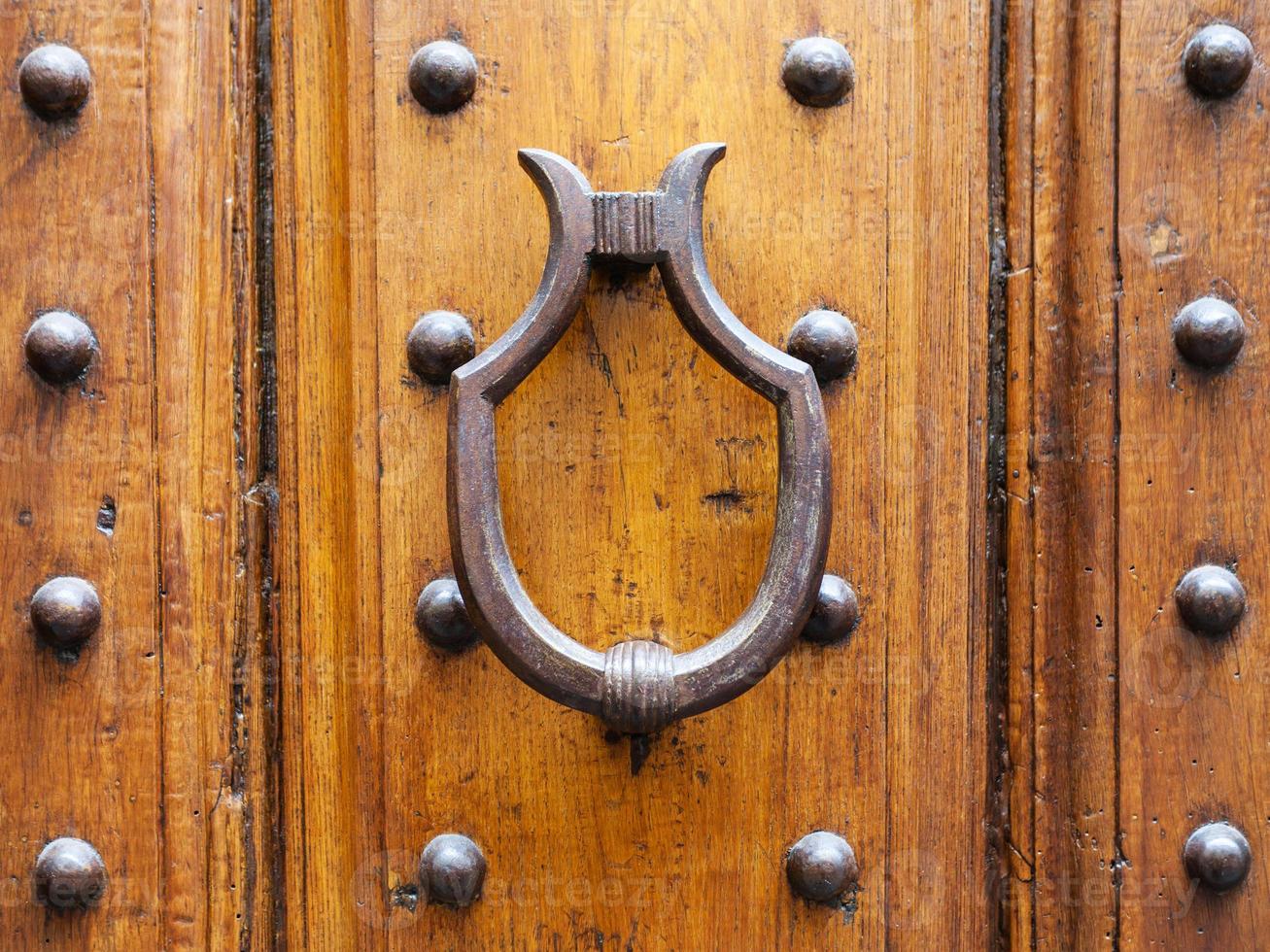 medieval knocker on old door in Florence city photo