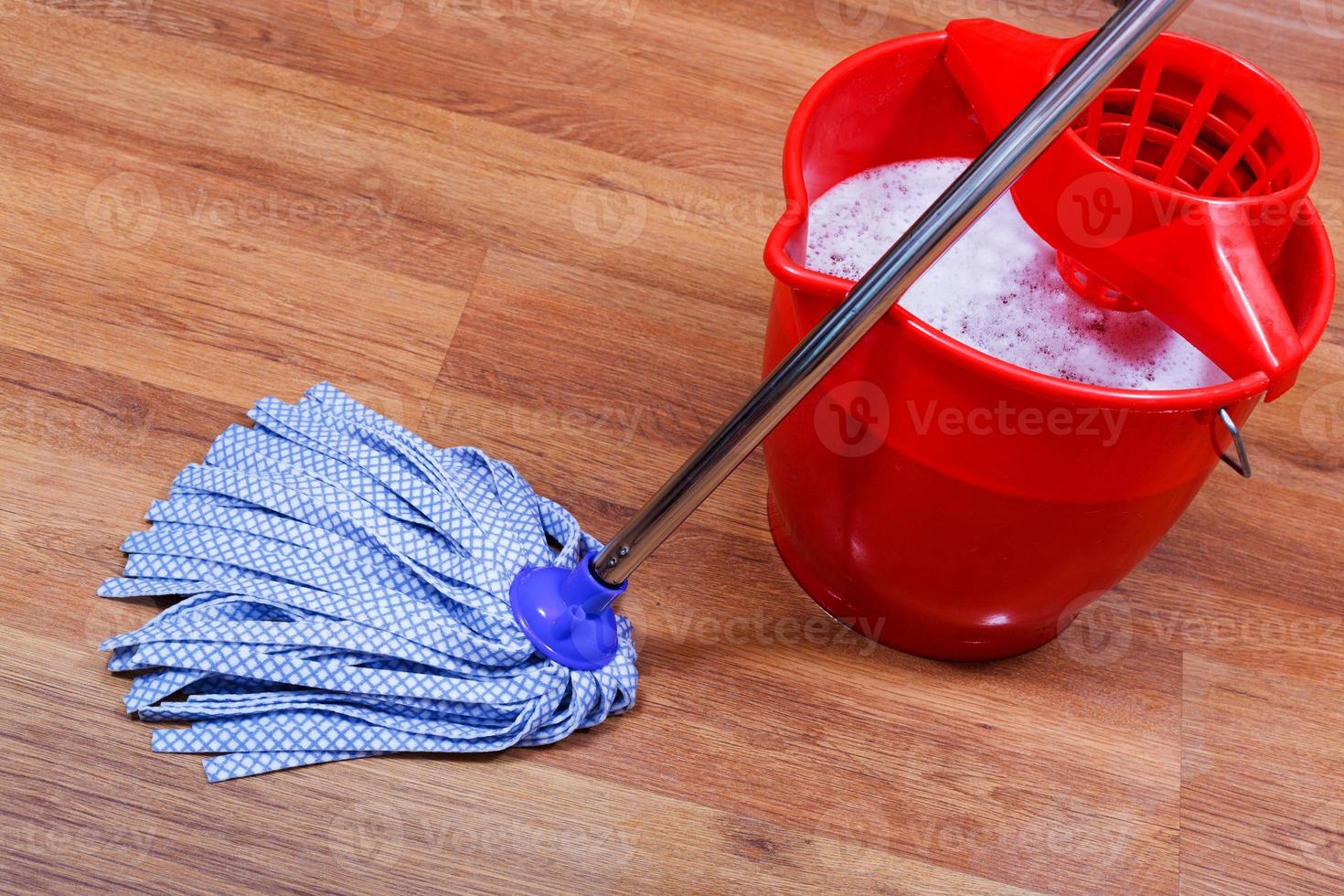 blue textile mop and red bucket photo