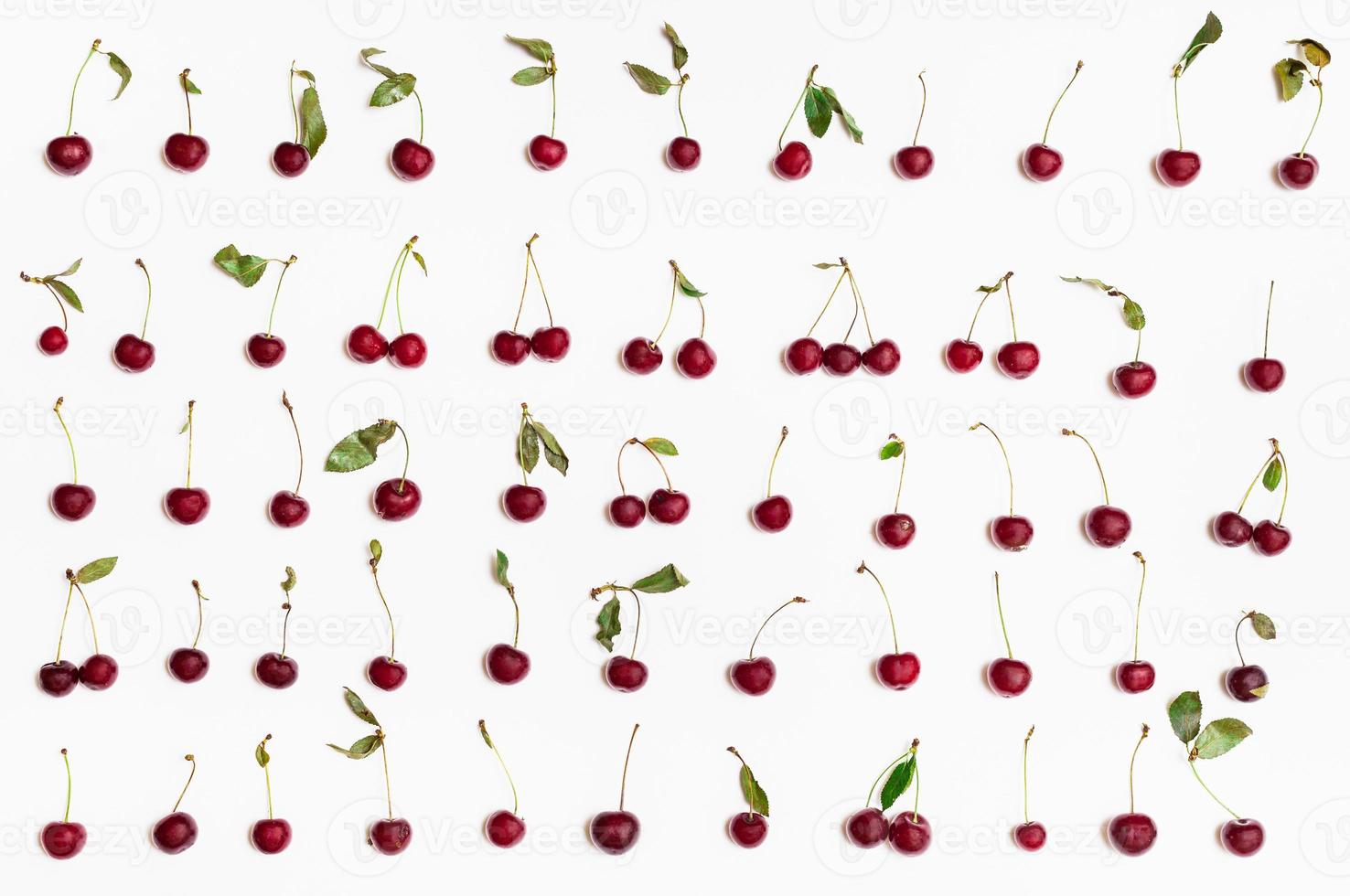 set from many ripe red cherries arranged on white photo