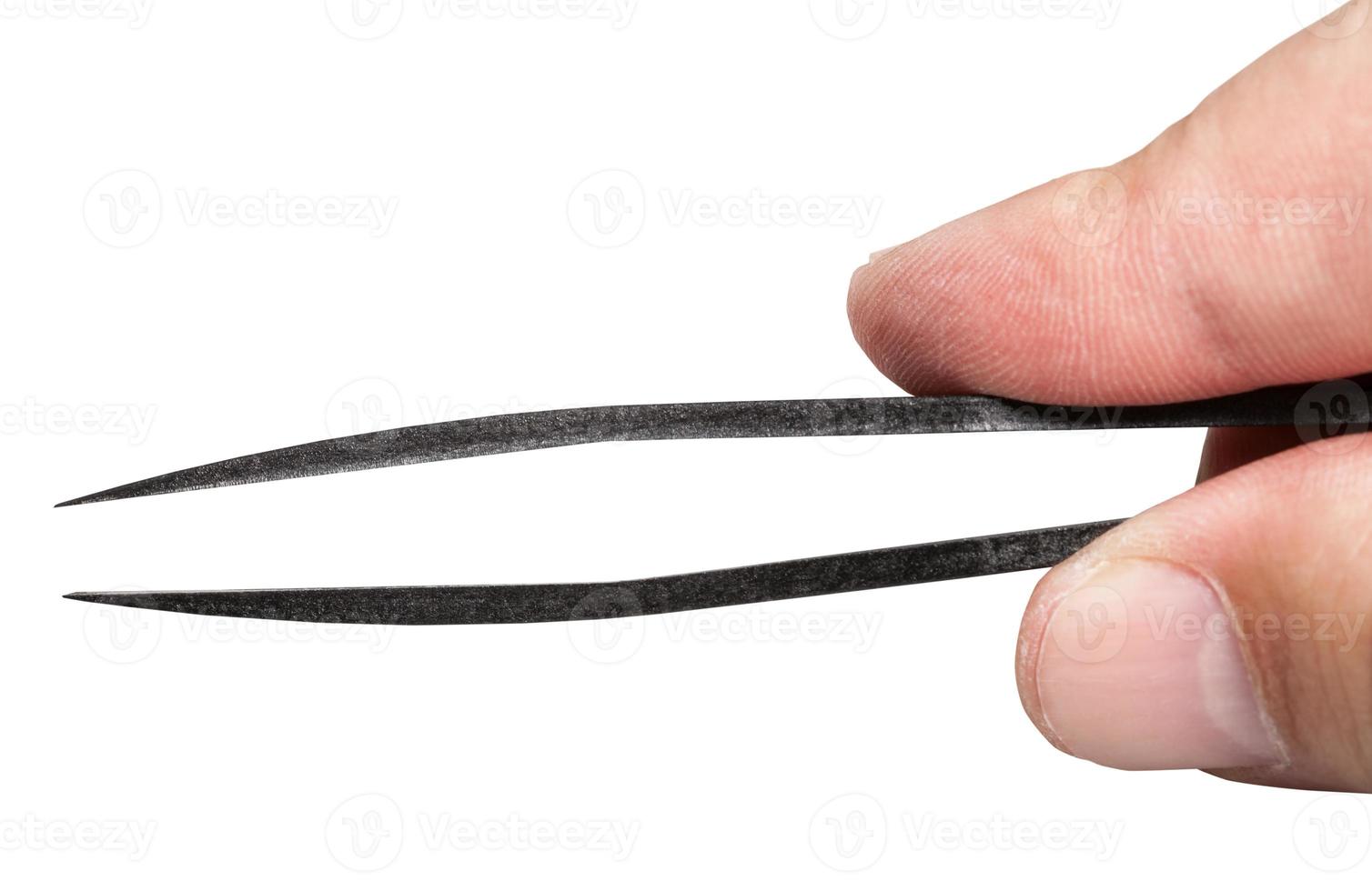 top view of male fingers holding plastic tweezers photo