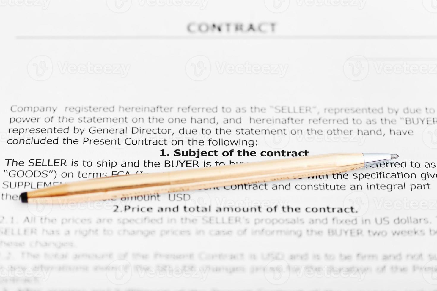 golden pen on sheet of sales agreement photo