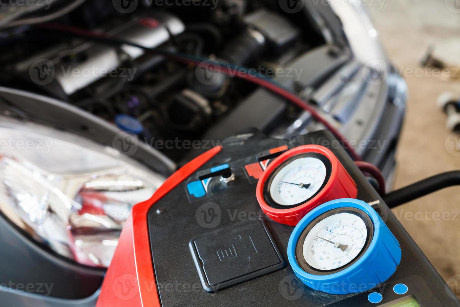 Refilling of car conditioner in auto repair shop photo