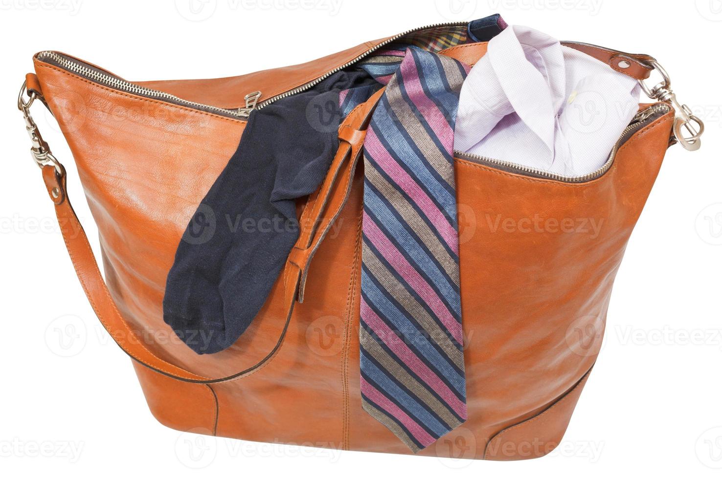 leather handbag with shirt, tie, sock isolated photo