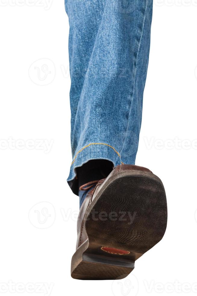 front view of left leg in jeans and brown shoe photo