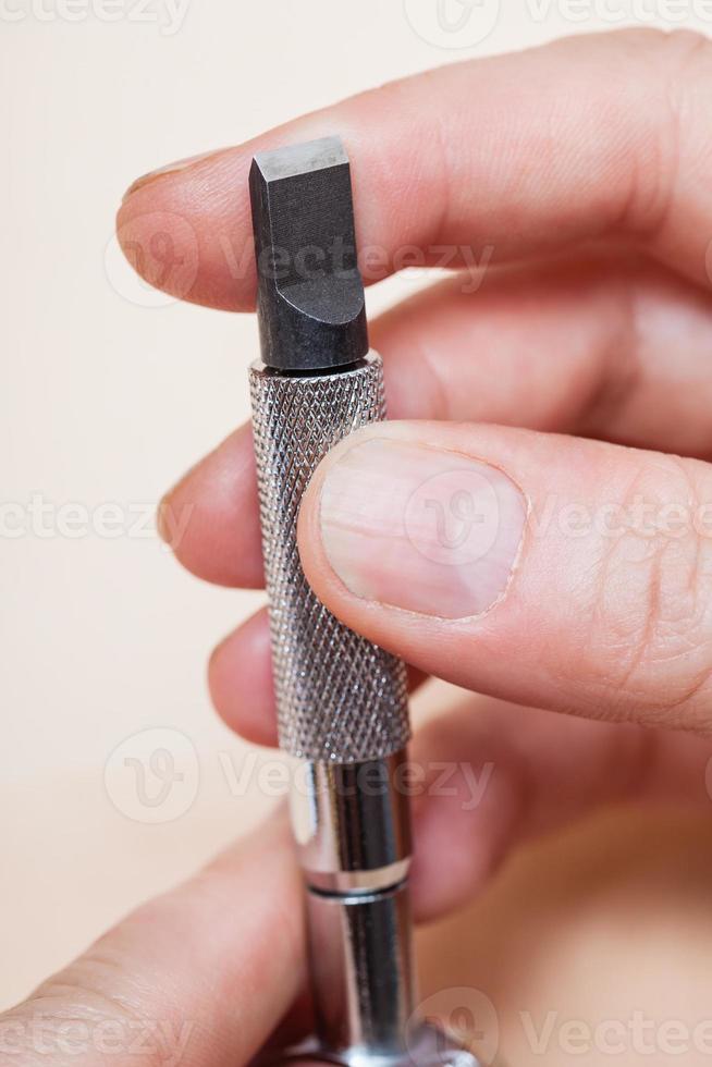 Swivel knife in hand close up 12243306 Stock Photo at Vecteezy