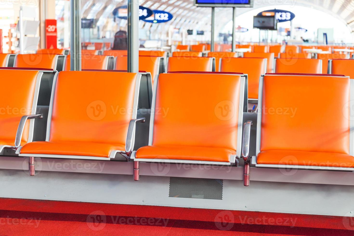 empty seat in departure area of airport photo