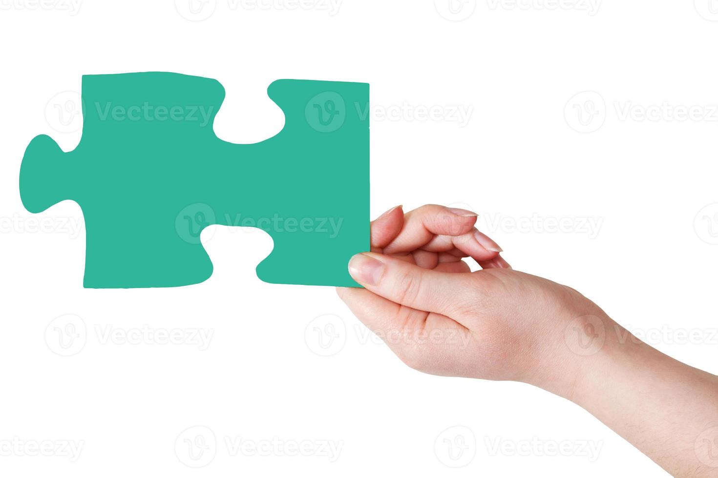 female hand with green puzzle piece photo