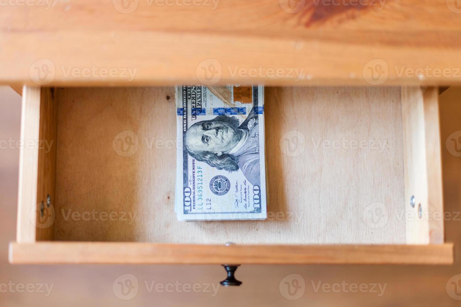 hundred-dollar bills pack in open drawer photo