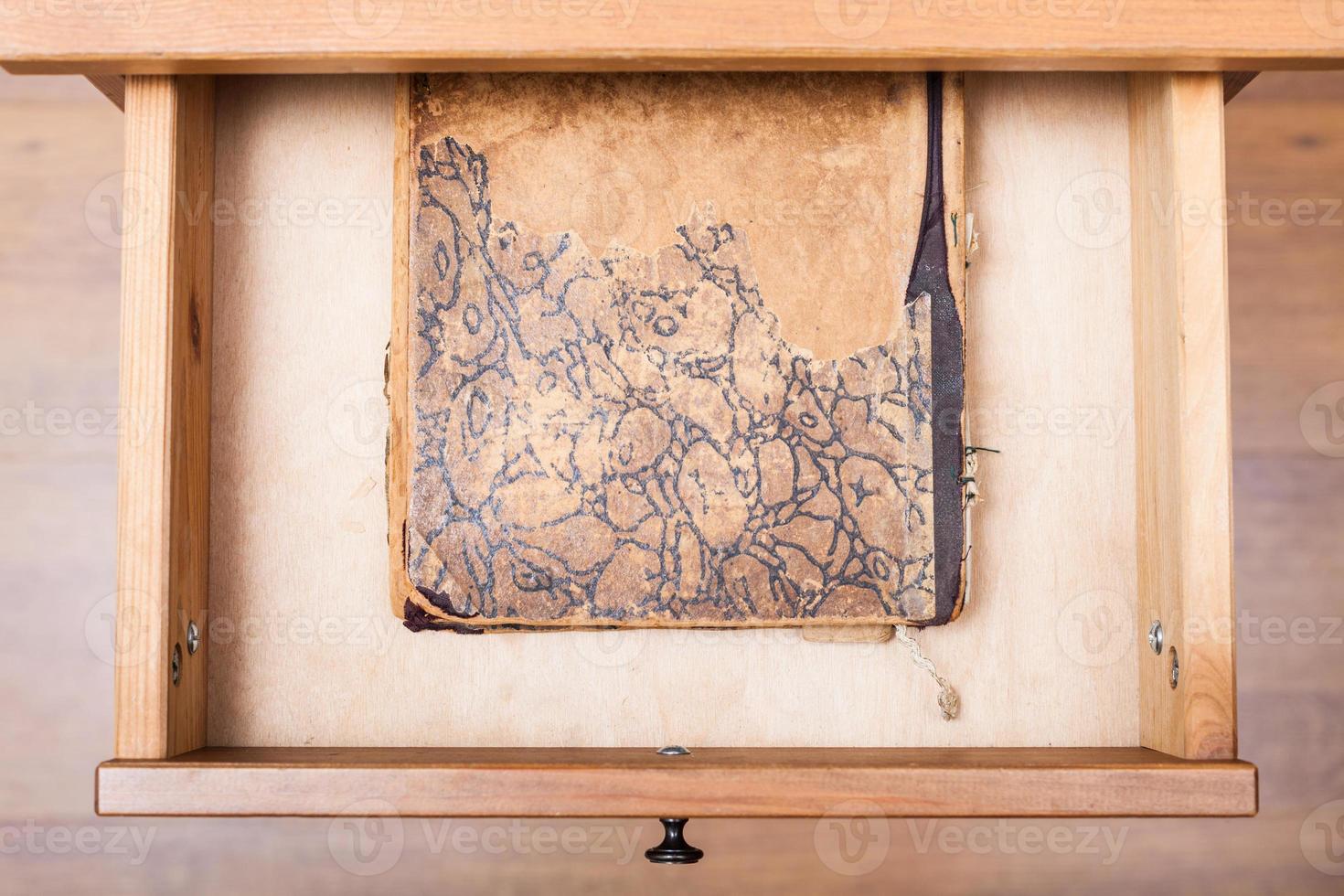 used book in open drawer photo