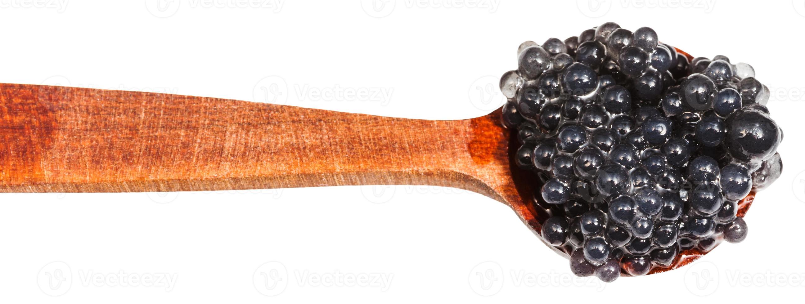 salty black dyed caviare of halibut in wood spoon photo