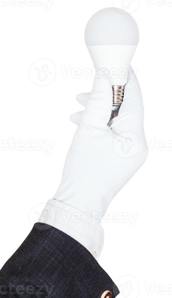 male hand in suit and glove holds LED lamp photo