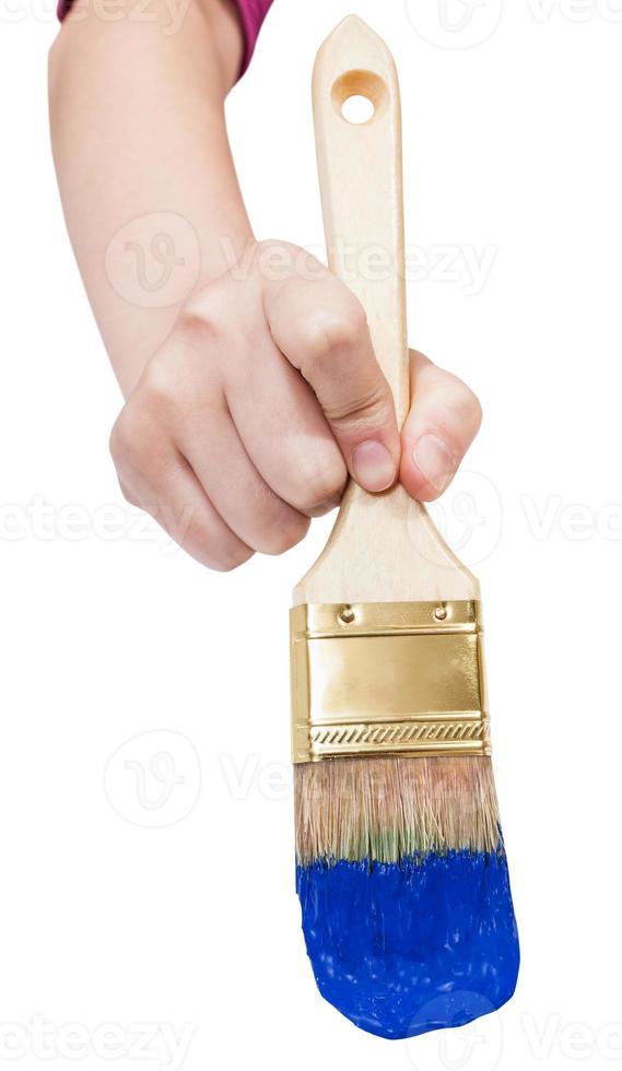 direct view of painter hand with blue paintbrush photo