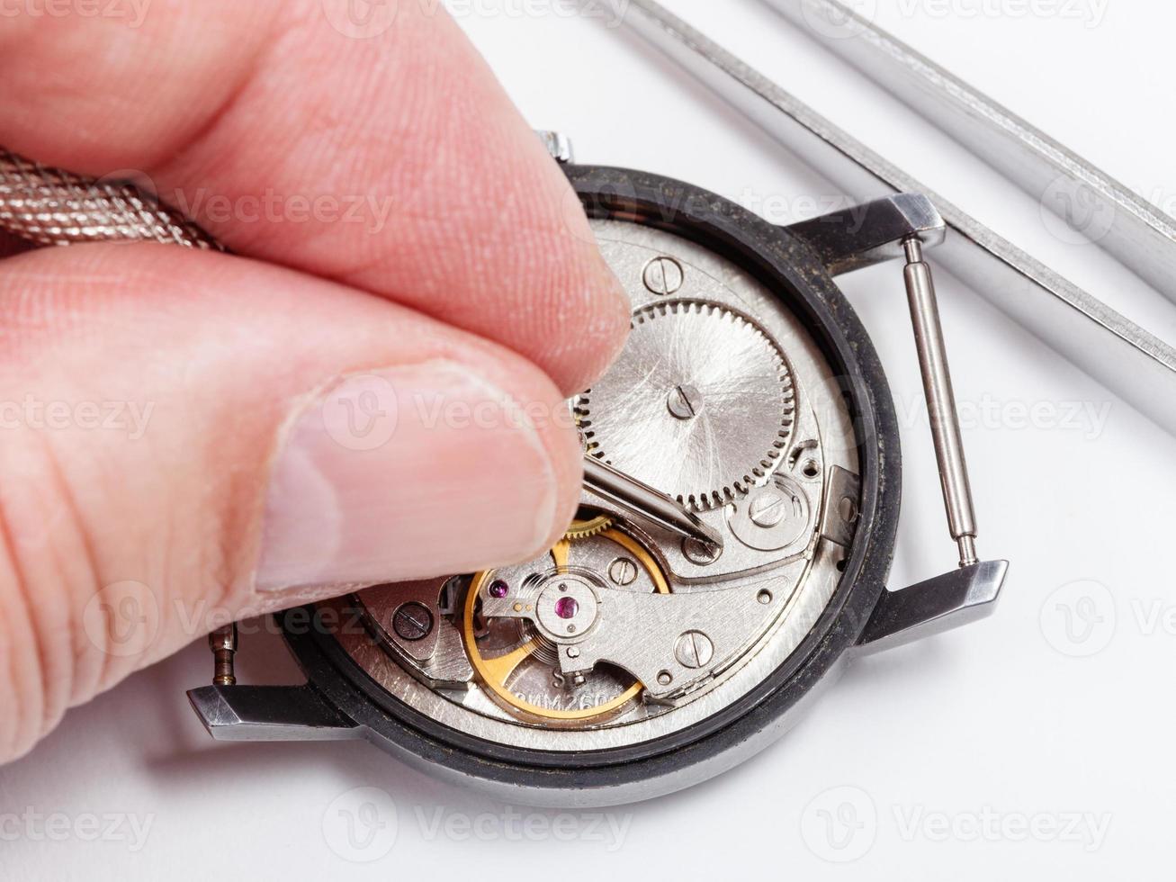 watchmaker repairs old watch close up photo