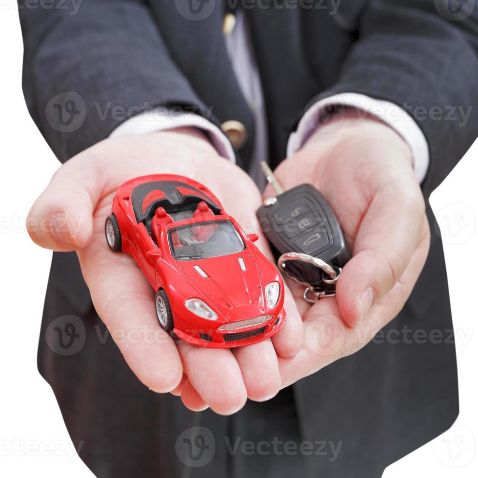 red car and key in seller's hand isolated photo