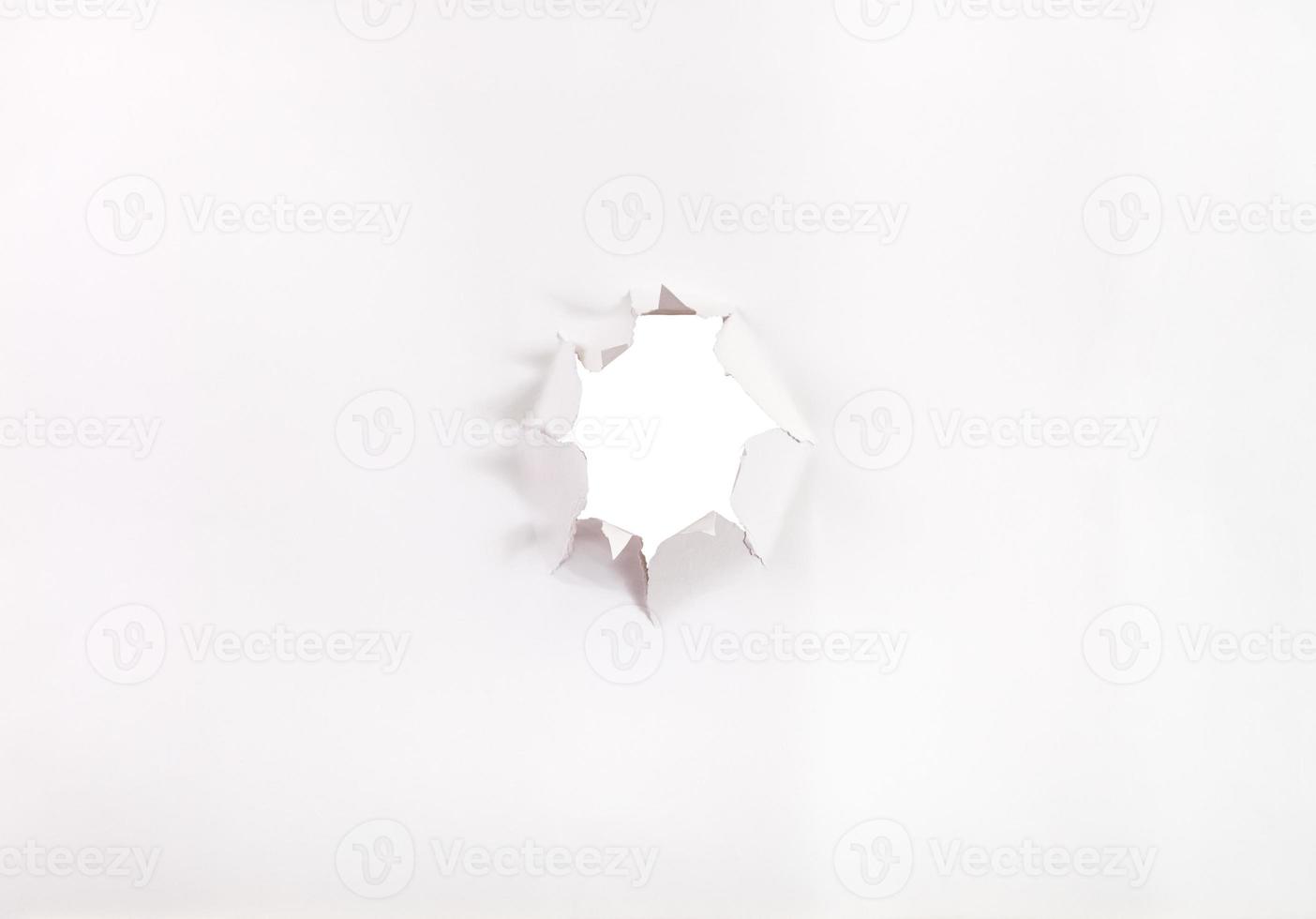 direct view of sheet of paper with punched hole photo