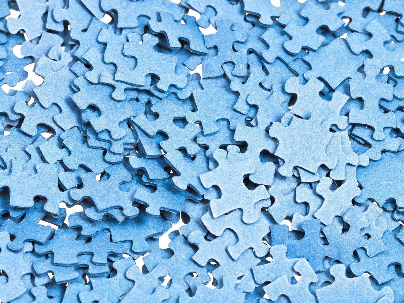 pile of separated blue puzzle pieces photo