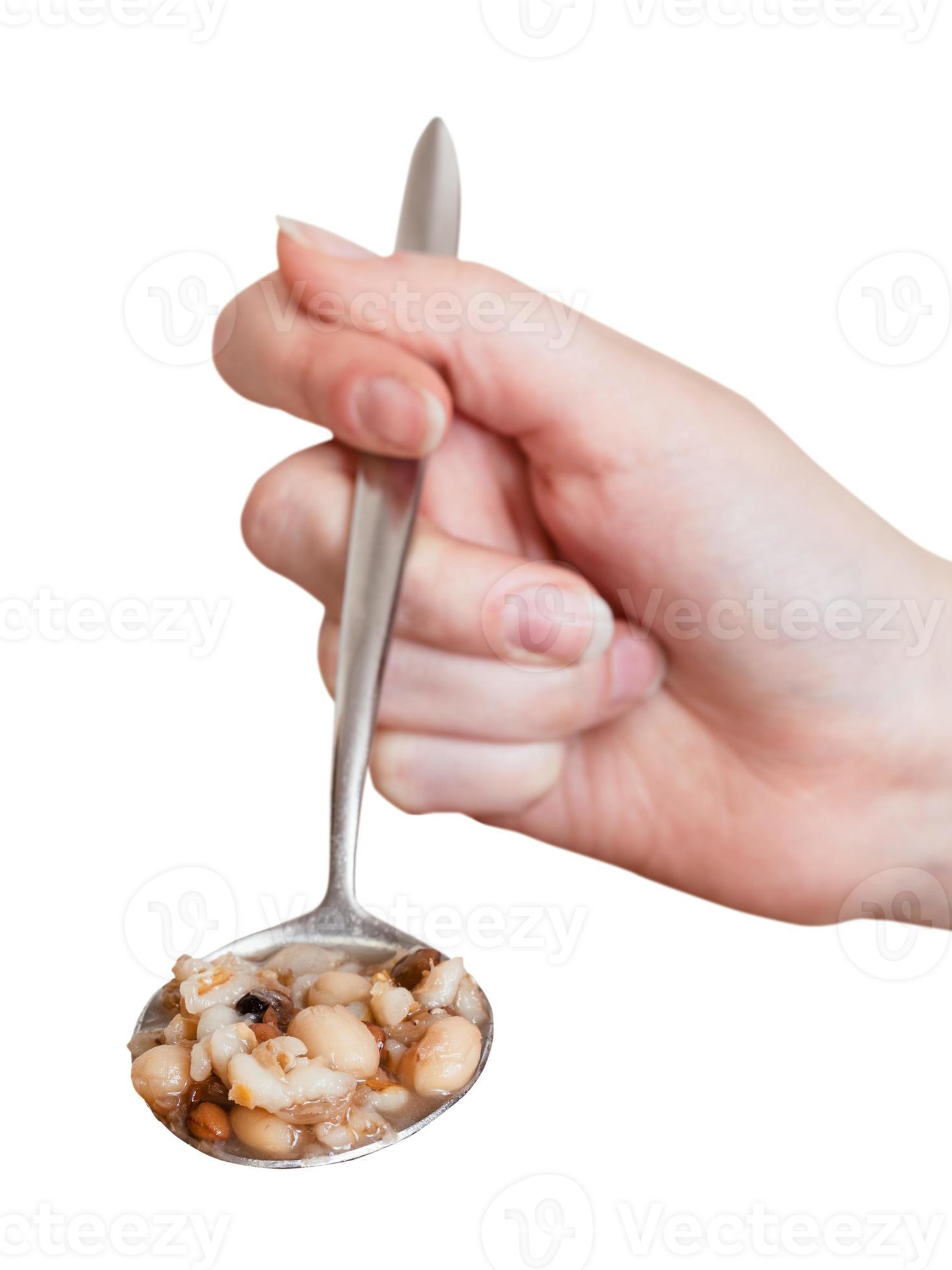 female hand holds tablespoon with beans soup 12244653 Stock Photo at