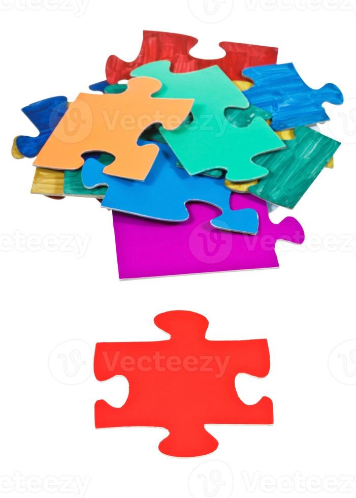red piece near pile of jigsaw puzzles photo