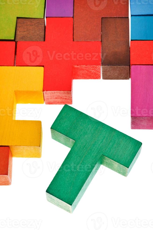 T-shaped piece in wooden multicoloured puzzle photo
