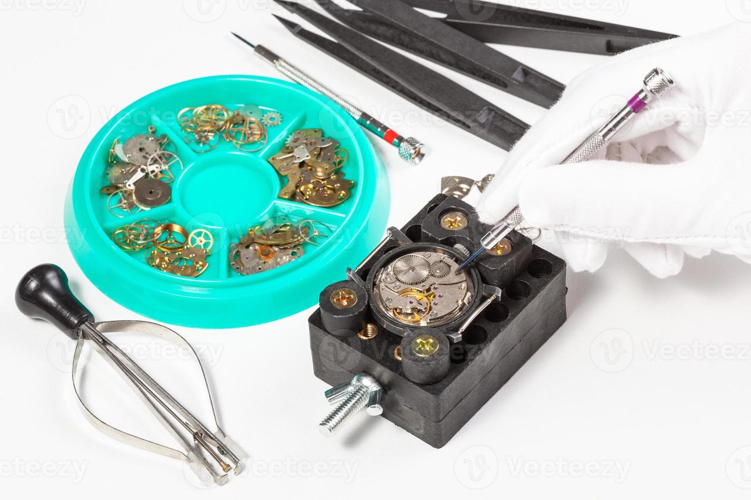 repair of old mechanic wristwatch on white table photo