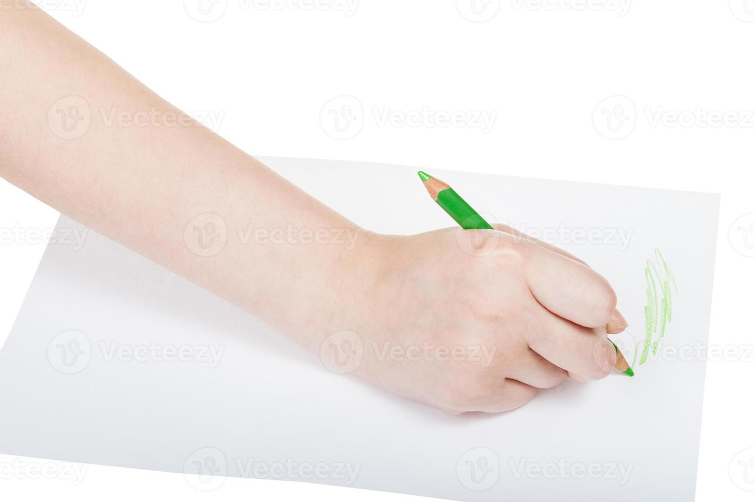 hand draws by green pencil on sheet of paper photo