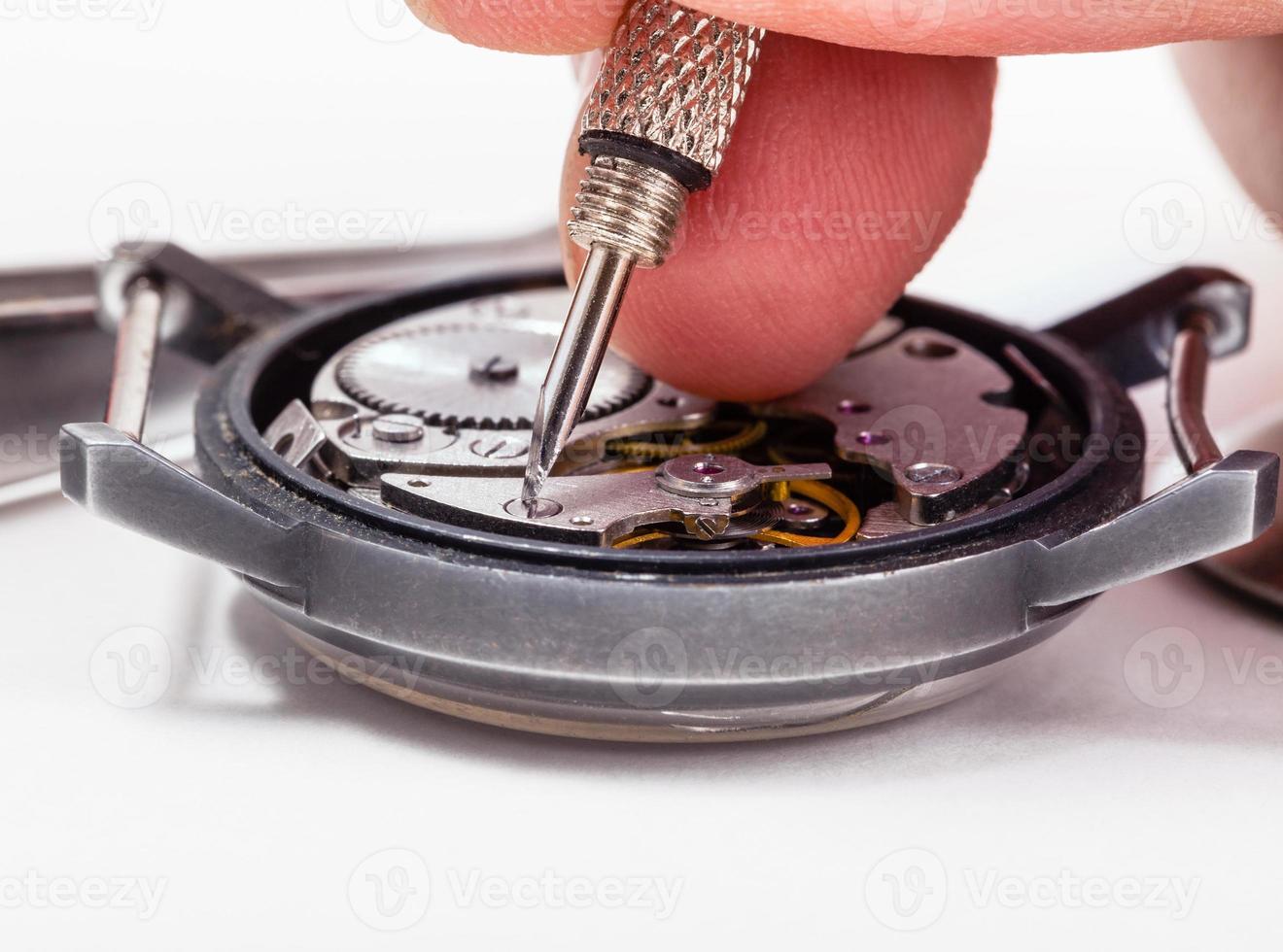 watch repairer repairs old watch close up photo