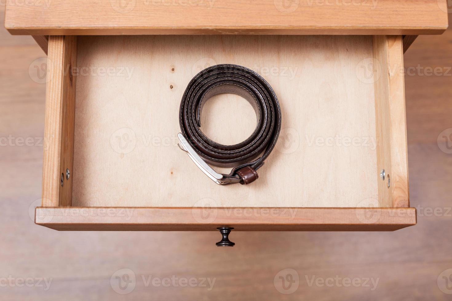 leather belt in open drawer photo