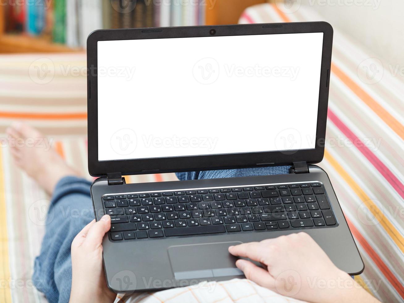 man works on laptop with cut out screen photo