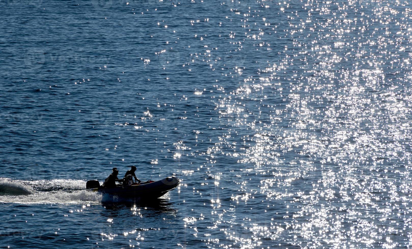 Inflatable zodiac on water photo