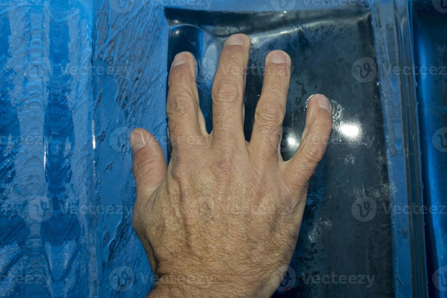 Hand on ice blocks wall photo