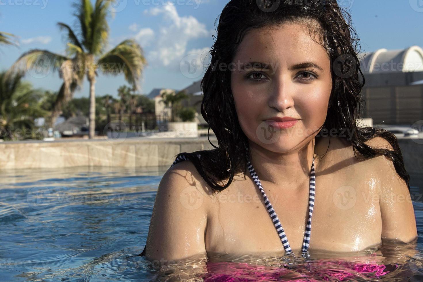 smiling black hair mexican latina girl portrait in Jacuzzi photo