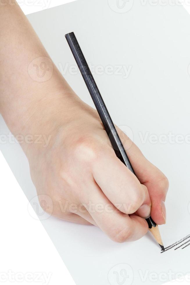 hand drafts by black pencil on sheet of paper photo